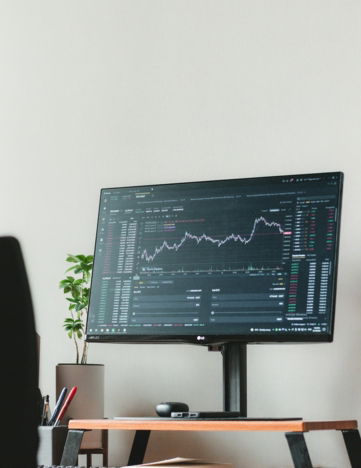 a computer monitor sitting on top of a wooden desk